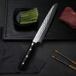 A carving knife is used to slice thin cuts of meat such as poultry, roasts, hams and other large cooked meats. The blade is thinner than a chef's knife for more precise slices of meat.