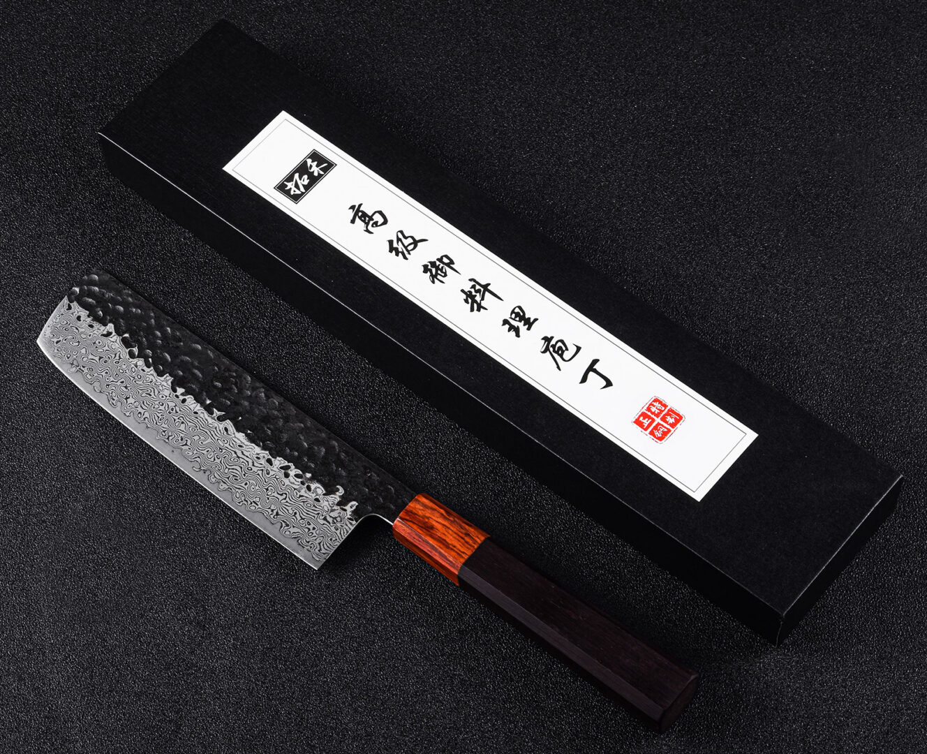 Under utilized in the western kitchen, the nakiri’s flat blade is meant for the push/pull chopping of vegetables. Since the entire flat edge of the knife ktouches the cutting board at once, you wont be turning the vegetable into an 'accordion', still connected like a paper doll after you've cut them. The added weight of the blade allow it to fall through food more easily while you chop, so the knife does more of the work for you! Masakage nakiris are made taller than the average nakiri so they last longer and work better for folks with large hands.