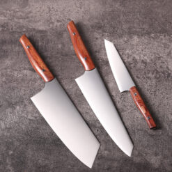 Chef knife, vegetable knife, and prep knife on textured surface