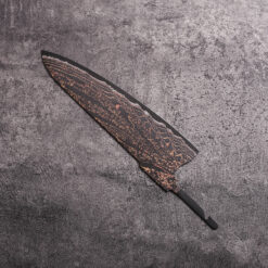 Close-up of Copper Mai Damascus pattern with copper shimmer on knife blank