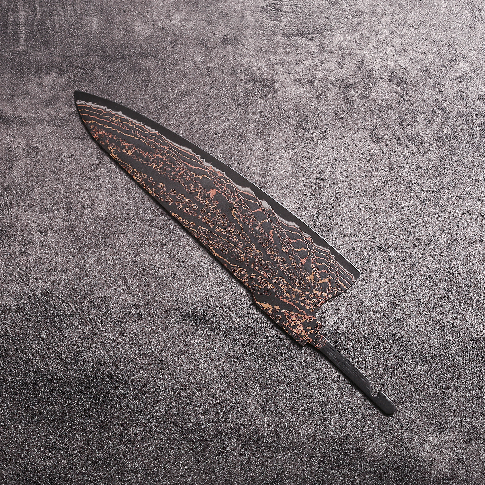 Close-up of Copper Mai Damascus pattern with copper shimmer on knife blank