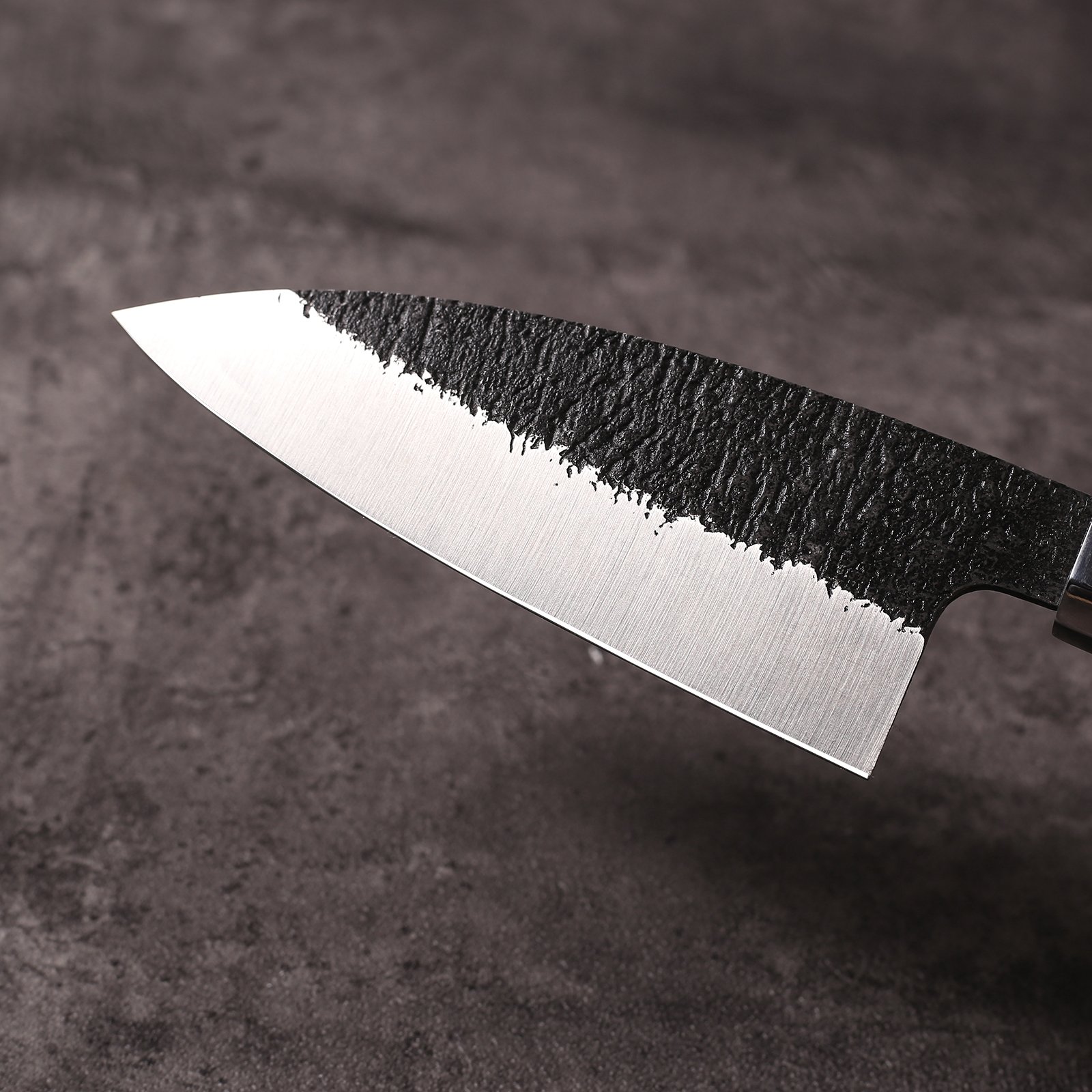 Textured kurouchi finish meeting polished bevel on AUS-10 ajikiri blade