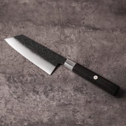 AUS-10 K-Bunka knife showing 45mm blade width and reverse-tanto tip, blade angled left