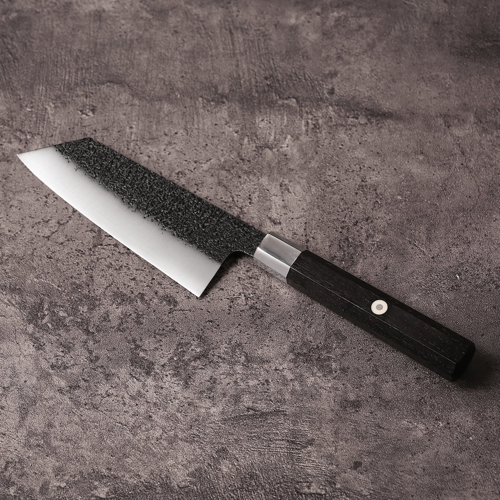 AUS-10 K-Bunka knife showing 45mm blade width and reverse-tanto tip, blade angled left