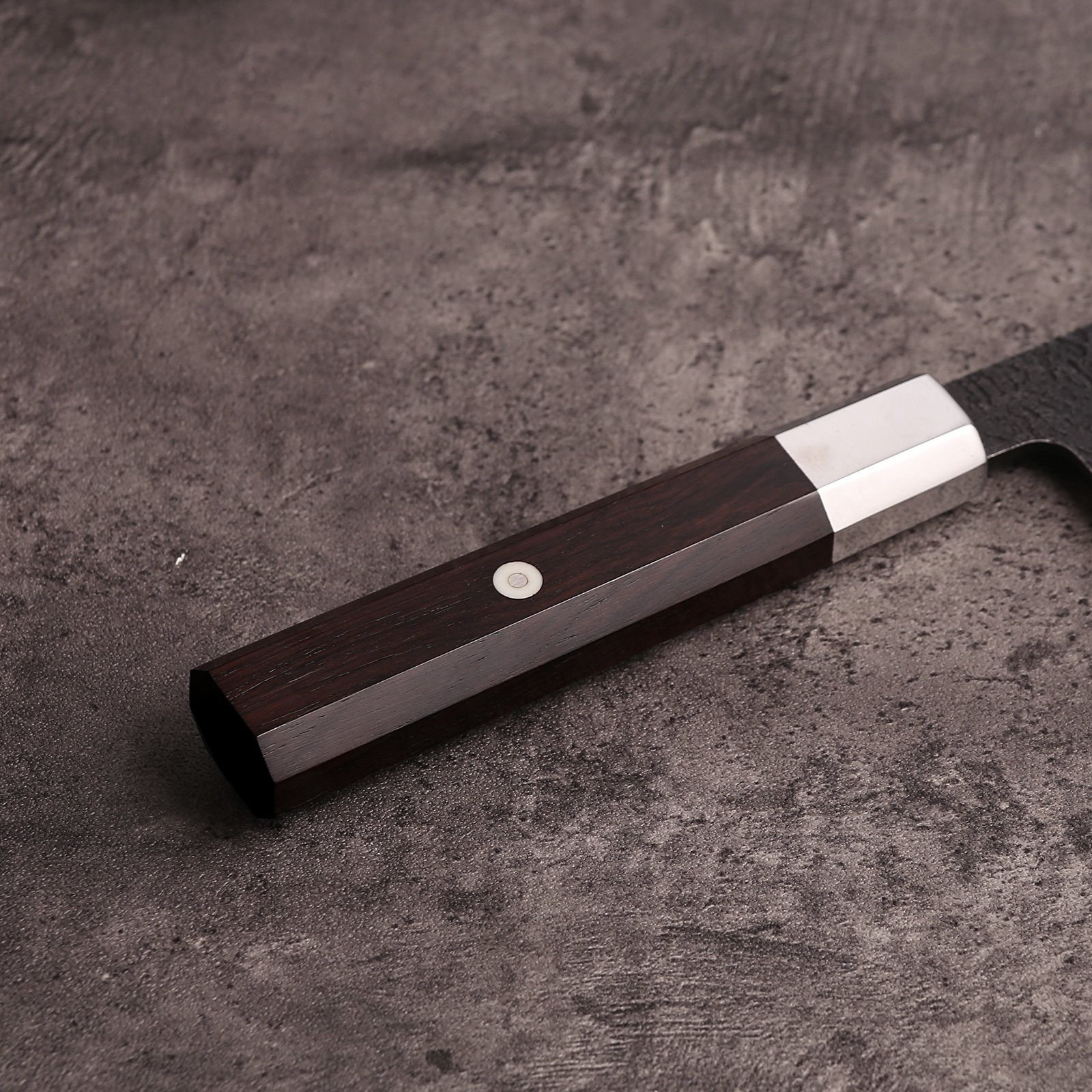 Octagonal ebony wa handle with 410 stainless cap and white pin on the AUS-10 santoku