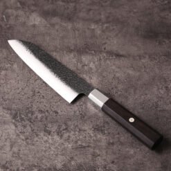 Reverse side of the santoku blade with textured kurouchi upper and polished bevel
